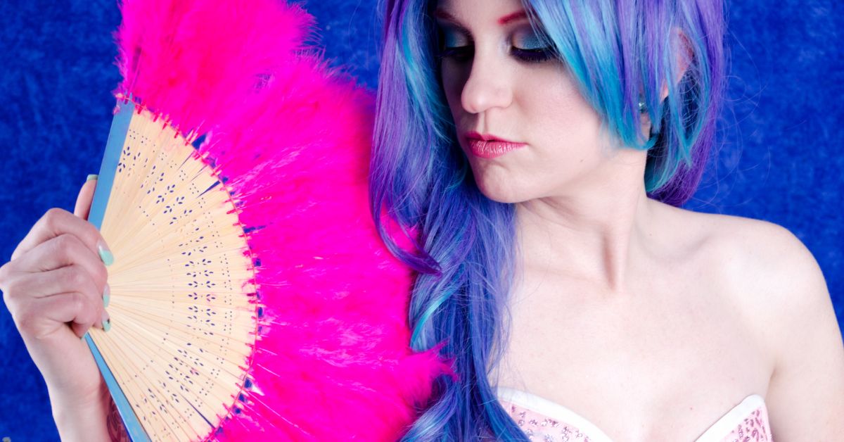 Burlesque dancer with pink feather fan